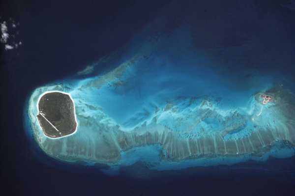This photograph shows details of the reefs surrounding Glorioso Island (îles Glorieuses), one group in the îles Eparses, that was taken 17 June 2001 from the International Space Station. The airfield, the only sign of habitation, is easily identified. Photo courtesy of NASA.