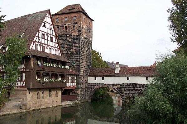Part of the Hangman&apos;s Bridge (Henkersteg; built 1457) in Nuremberg. The city executioner used to live in the tower and the roofed walk above the River Pegnitz. Considered a &quot;persona non grata,&quot; the hangman was avoided by the citizens of the city.