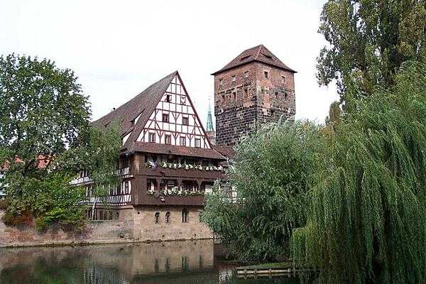 River view of the half-timbered Weinstadel (former wine depot) on the Pegnitz River flowing through Nuremberg.