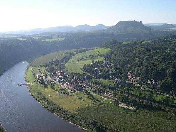 The town of Oberrathen along the Elbe River as seen from the Bastei, a rocky sandstone prominence.