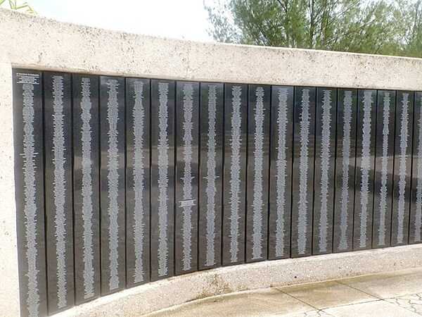 The Asan Bay Overlook Memorial Wall at the War in the Pacific National Historical Park. The Wall contains the names of 1,880 US servicemen who died in the 1941 defense of Guam against attacking Japanese armed forces and those who died retaking the island from Japan in 1944 along with the names of the 1,170 people of Guam who died and 14,721 who suffered atrocities of war from 1941-1944. Photo courtesy of the US National Park Service.