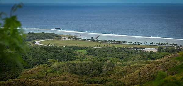 View from Asan Bay Overlook toward the War in the Pacific National Historical Park. This photo illustrates the perspective of the Japanese defenders when US forces landed on 21 July 1944. Despite an intense pre-invasion bombardment, the 3rd Marine Division encountered significant opposition as they came ashore on the beaches of Asan Bay. Photo courtesy of the US National Park Service.