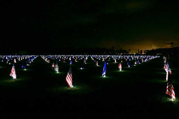 A nighttime display of flags during a Memorial Day flag event. The alternating flags are those of the United States and Guam. Photo courtesy of the US National Park Service.