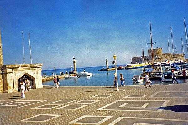 Mandraki Harbor at Rhodes, the site of a third century B.C. statue to the Greek sun god, Helios. Standing some 30 m (100 ft)  high, it became known as the Colossus of Rhodes, and was considered one of the Seven Wonders of the Ancient World.