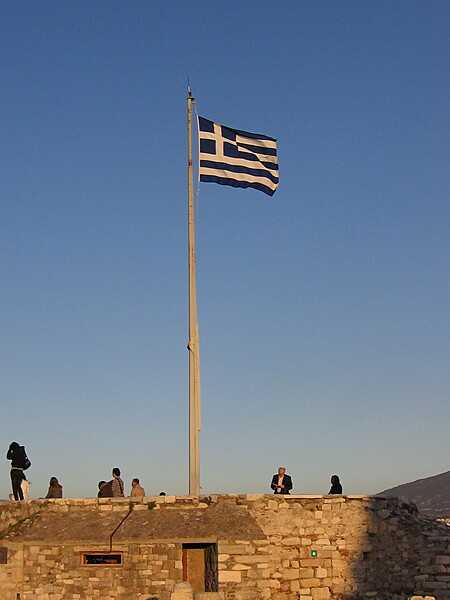 The Greek flag flies over the Acropolis.