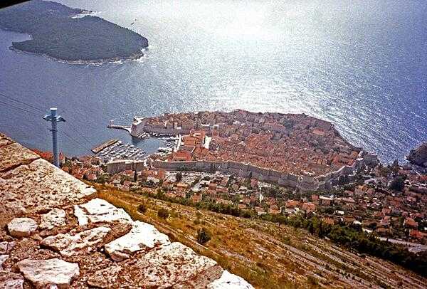From a cliff overview, one can see the enormous walls and large harbor of old Dubrovnik.