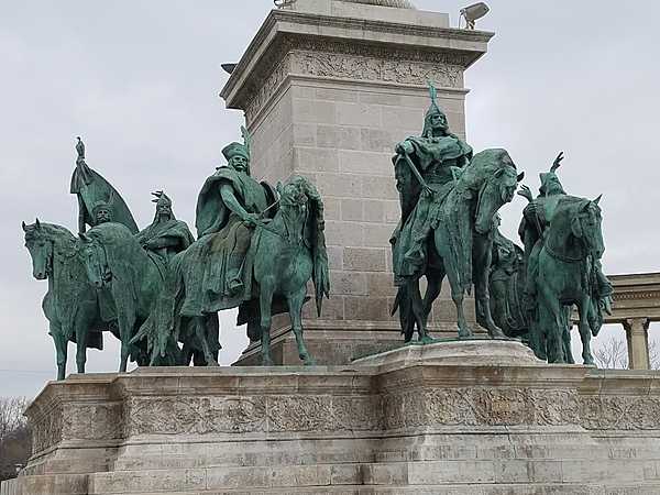 Statues of seven mounted figures at the base of the Millennium Monument column represent the Magyar chieftains who led the Hungarian people to their settlement in the Pannonian Plain of central Europe.