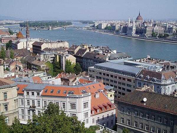 A view of the Danube River that splits Buda and Pest (which together are Budapest), as seen from Buda; the Parliament Building is visible in the distance.
