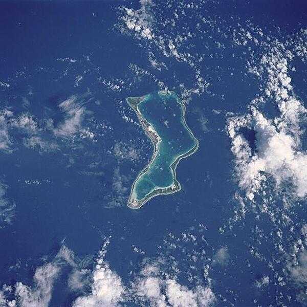 The largest of the coral atolls of the Chagos Archipelago, Diego Garcia, is visible in this northwest-looking view. Diego Garcia is approximately 560 km (350 mi) south of the Maldive Islands in the central Indian Ocean. The crescent shape of the coral island encloses a lagoon that forms the harbor. Diego Garcia is the site of a large Anglo-American Naval Air and Communications facility located on the northwest part of the atoll. Image courtesy of NASA.