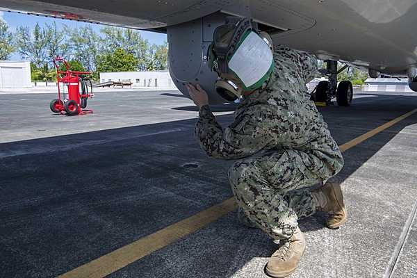A crew member from US Navy Patrol Squadron (VP) 45, inspects a sensor on a Boeing P-8 Poseidon aircraft onboard US Navy Support Facility (NSF) Diego Garcia. The aircraft from Patrol Squadron 45 made a transit stop onboard NSF Diego Garcia from 1-3 December 2019. Photo courtesy of the US Navy/ Mass Communication Specialist 3rd Class Jillian F. Grady.