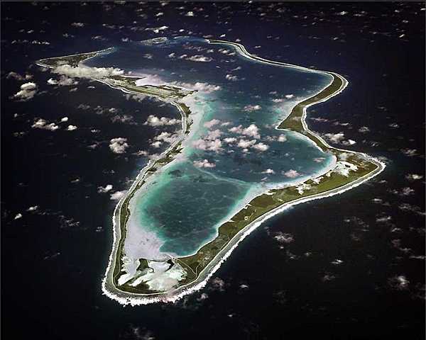 An aerial view of the island of Diego Garcia in the British Indian Ocean Territory.  Diego Garcia is the location of an important UK and US air and naval base supporting operations throughout the Indian Ocean basin. The lagoon provides an excellent sheltered deep water anchorage. Photo courtesy of US Navy.