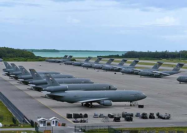 US Air Force KC-10A Extender aerial refueling aircraft, left, and C-17 Globemaster III cargo aircraft are parked on the ramp at Naval Support Facility Diego Garcia. This photo illustrates the surge capacity for staging strategic forces into the Indian Ocean basin. The joint UK and US base on Diego Garcia provides logistics support to overseas contingency operations. Photo courtesy of the US Navy/ Mass Communication Specialist 3rd Class Caine Storino.