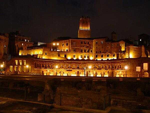 A nighttime view of Trajan&apos;s Market in Rome. Now a complex of ruins, it was built in A.D. 100-110. Its upper floor was filled by offices; a road divided it  from the lower floor, which held shops.