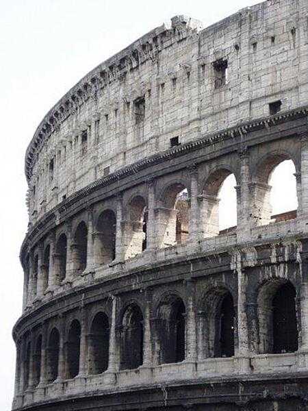 A view of the upper portions of the Roman Colosseum showing many of its arches.