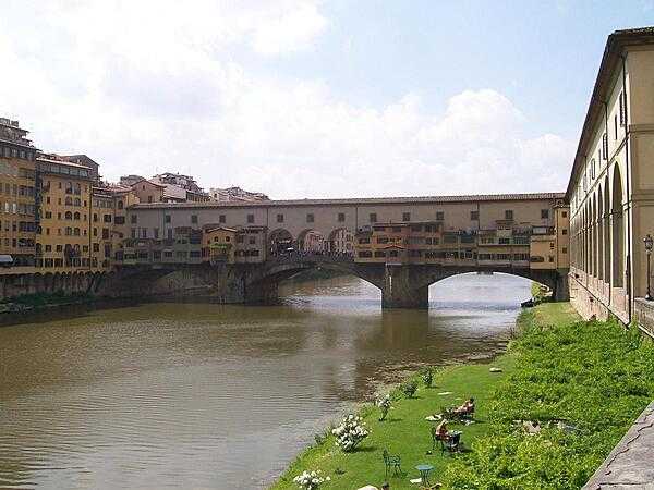 The Ponte Vecchio (Old Bridge) spans the Arno River in Florence; since Medieval times it has hosted shops and merchants along its length.