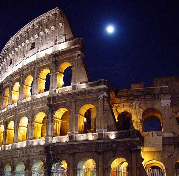 A nighttime view of the Roman Colosseum.