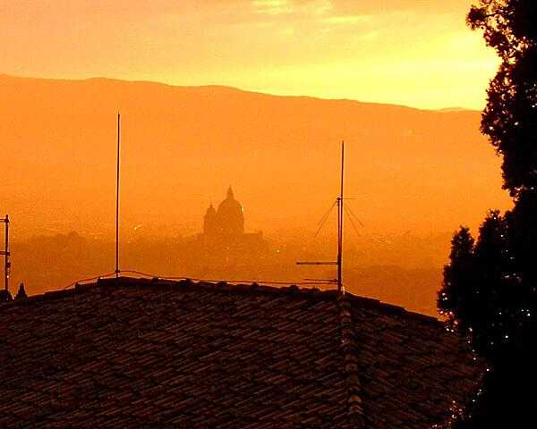 Dawn in Assisi reveals the dome of the Basilica of Santa Maria degli Angeli (St. Mary of the Angels).