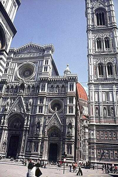 The facade of the Basilica di Santa Maria del Fiore (Saint Mary of the Flowers) in Florence. Begun in 1296, the magnificent structure was not finished until 1436. The entire cathedral complex consists of the church itself, the free-standing campanile (bell tower), and the Baptistery, which stands across the square (portion seen in upper left).