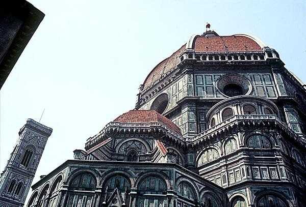 A look up at the dome of the Basilica di Santa Maria del Fiore (Basilica of Saint Mary of the Flower) in Florence. Until modern times the dome - engineered by Brunelleschi - was the largest in the world. It remains the largest brick dome ever constructed. The campanile - designed by Giotto - appears on the left.
