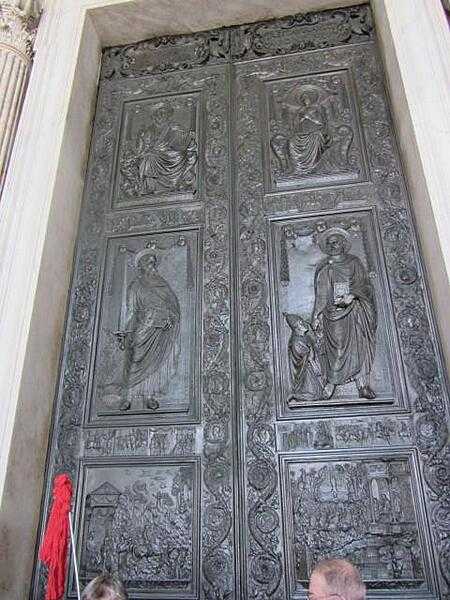 Decorated doors leading into Saint Peter&apos;s Basilica in Rome.