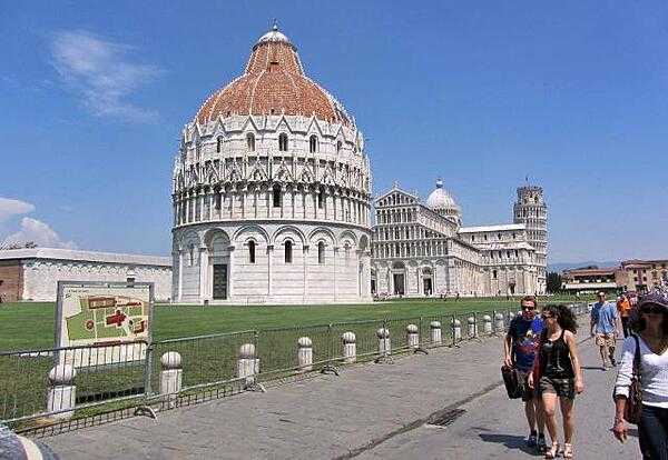 The Battistero di San Giovanni (Baptistry of St. John) in Pisa dates to 1153. The building on the left is the Camposanto or walled cemetery. To the right is the Duomo (Cathedral) and the Campanile (Leaning Tower).