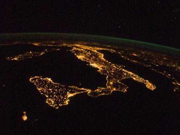 The &quot;boot&quot; of Italy is visible running diagonally southward from the horizon across the center of the frame, with the night lights of Rome and Naples being visible on the coast near the center. Sardinia and Corsica are just above left center of the photo, and Sicily is at lower left. The Adriatic Sea is on the other side of Italy, and beyond it to the east and north can be seen parts of several other European nations. Image courtesy of NASA.
