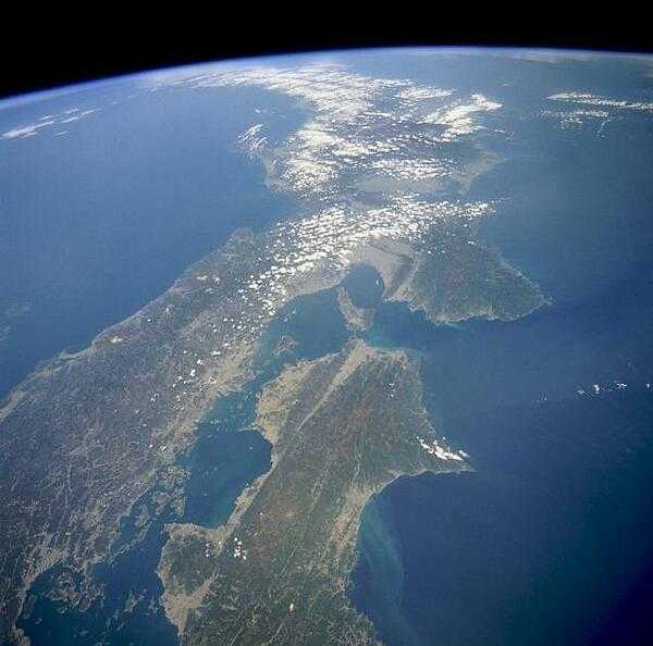 This high-oblique, northeast-looking space shuttle photograph captures a portion of Southern Honshu Island and Shikoku Island of Japan. The darker areas show volcanic, mountainous terrain that comprises more than 80 percent of Japan; the lighter, more highly reflective areas of the coastal plains and valleys are urban and agricultural areas. Separated by the Seto Inland Sea are Shikoku Island to the south and the Osaka-Kobe industrial metroplex on Honshu Island to the north. Photo courtesy of NASA.