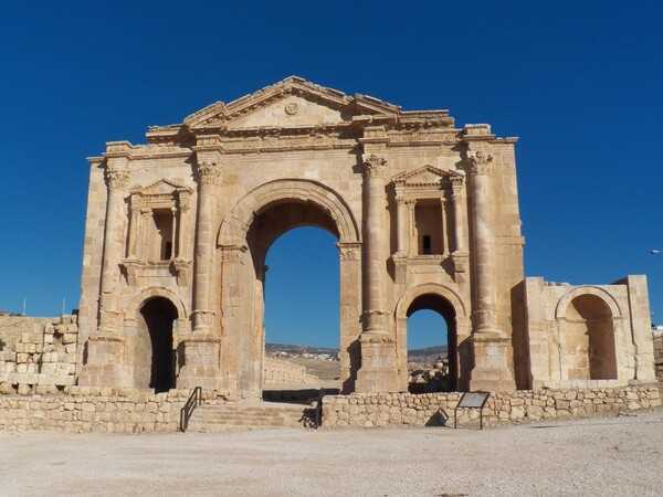 The Arch of Hadrian was built to honor the visit of Roman Emperor Hadrian to Jerash (then called Gerasa) in the winter of A.D. 129-130.  The arch is 11 m high (36 ft), 37.45 m long (122 ft), and 9.25 m wide (30 ft wide). To the left and behind the arch is the Hippodrome, where chariot races were held.