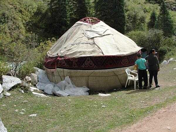 A typical Kyrgyz yurt, a portable, bent-wood framed shelter covered by layers of fabric, typically felt.
