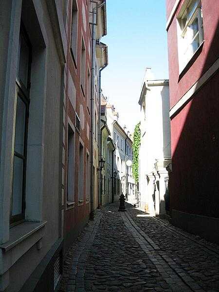Morning sunlight illuminates a clean swept alley way in Riga.