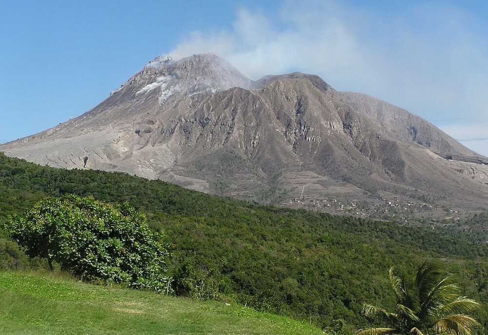 The long-dormant Soufrière Hills volcano on the island of Montserrat stands 1,050 m (3,444 ft) tall and became active in 1995, with its most recent eruption in 2013. A massive eruption in 1997 destroyed most of the capital, Plymouth, and rendered the southern part of the island uninhabitable. The government was moved to Brades Estate and other areas in the northwestern part of the island.