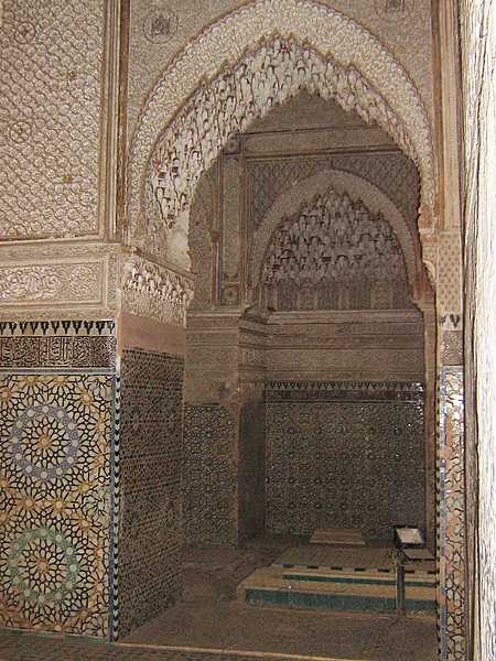The Saadian Tombs are a historic royal necropolis in Marrakech that date to the time of the Saadian Dynasty (1549-1659). They are located on the south side of the Kasbah Mosque, inside the royal kasbah (citadel) district of the city. Because of the beauty of their decoration, the tombs have become a major attraction for visitors to Marrakech. This view offers a glimpse into the Chamber of the Three Niches from the main mausoleum.
