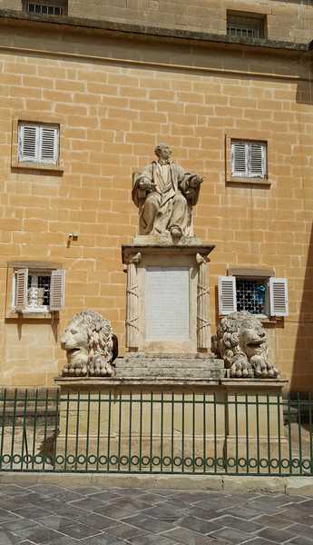This statue of Maltese judge and man of letters, Giuseppe Nicolò Zammit, is in the Upper Barrakka Gardens; it was commissioned by the first British Governor, Thomas Maitland, upon Zammit’s death. Born around 1768, Zammit started practicing law on 28 May 1792. He was appointed judge on 27 May 1814, and became vice-president of the Court of Appeal on 1 January 1821.  Zammit served in official posts under the Order of St John and the British, and was knighted in 1818.  He died on 7 September 1823.