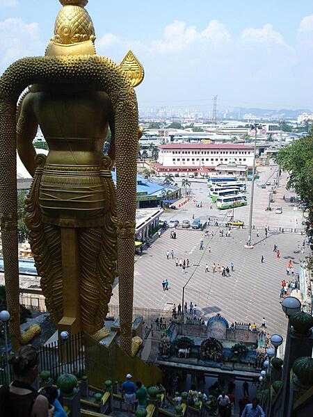 The statue of Lord Murugan, a Hindu deity, overlooks the plaza before the Batu Caves.
