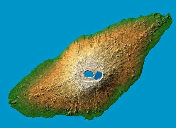 Periodically active volcano Mt. Manaro is the dominant feature in this shaded relief image of Aoba (Ambae) Island, part of the Vanuatu Archipelago located 2,250 km (1,400 mi) northeast of Sydney, Australia. The 1,496 m (4,908 ft) high Hawaiian-style basaltic shield volcano features two lakes within its summit caldera, or crater. Two visualization methods were combined to produce the image: shading and color coding of topographic height. The shade image was derived by computing topographic slope in the northwest-southeast direction, so that northwest slopes appear bright and southeast slopes appear dark. Color coding is directly related to topographic height, with green at the lower elevations, rising through yellow and tan, to white at the highest elevations. Image courtesy of NASA.