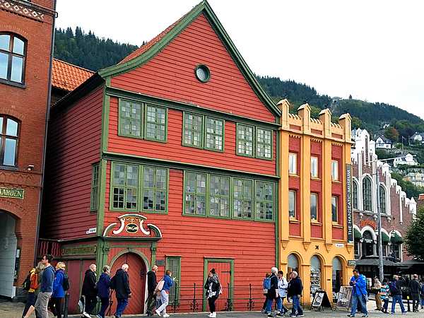 Brightly painted warehouses along the Hanseatic Wharf in Bryggen, the dock area of historic Bergen.  The yellow and orange building is the Hanseatic Museum. The Bryggen  has been a UNESCO World Cultural Heritage site since 1979.