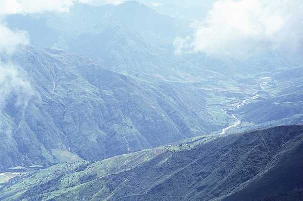 Dramatic aerial view of a valley in the Himalayas. Note the terracing on the hillsides.
