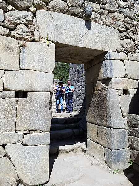Impressive archway in Machu Picchu. The Incas constructed their windows and doors in a trapezoidal form (wider at the base and narrower at the top) because this shape provided greater stability during earthquakes.