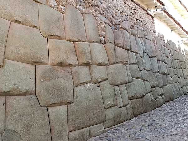 Ancient Andean civilizations are well known for their monumental architecture, which reached its height in the Inca Empire of the 15th and 16th centuries. The photo shows a close up of a typical Inca wall in Cusco (the Incan capital city) constructed without mortar and with no spaces between the enormous blocks of stone. Exactly how the blocks were fitted remains unclear, but we know they were constructed by human ingenuity - not ancient aliens!