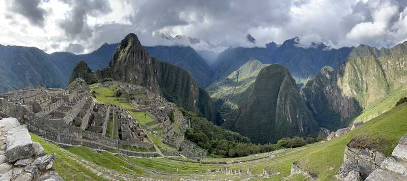 A panoramic view of Machu Picchu showing this UNESCO World Heritage Site in its dramatic mountainous setting. The photo was taken from the site's terraces.