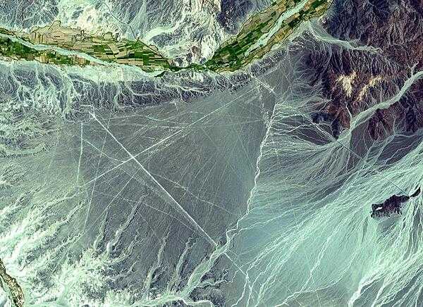The Nasca Lines, located in the desert coastal plain of Peru 400 km south of Lima, were first observed in the 1920s when commercial airlines began operating in the area. Clearly seen from the air, the Lines were made by removing the iron-oxide coated pebbles which cover the surface of the desert. The lighter shade of the exposed ground contrasts with the color of the gravel. South of the Nasca Lines, archaeologists have now uncovered the lost city of the Line-builders. Known as Cahuachi, it was built nearly 2,000 years ago and was mysteriously abandoned 500 years later.
Image courtesy of NASA.