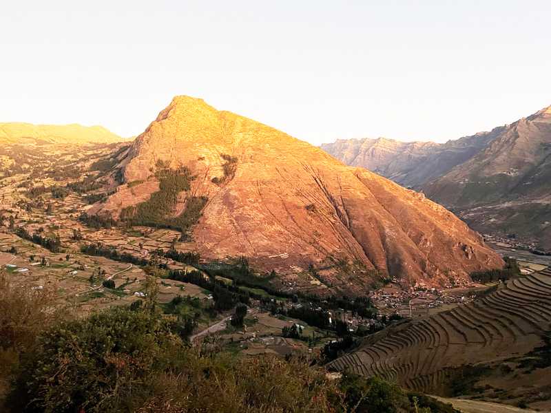 The setting sun illuminates the mountains overlooking Pisac, an Incan village that is the site of some of the largest terraces in the Sacred Valley.