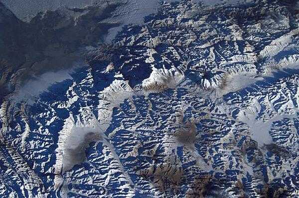 This view shows K-2 Mountain (upper center) in Pakistan, the world&apos;s second highest peak, as seen from the International Space Station. The mountain (8,611 m; 28,251 ft high) is sometimes referred to as Savage Mountain, because of the difficulty of its ascent and the many lives lost in attempting its climb. Image courtesy of NASA.
