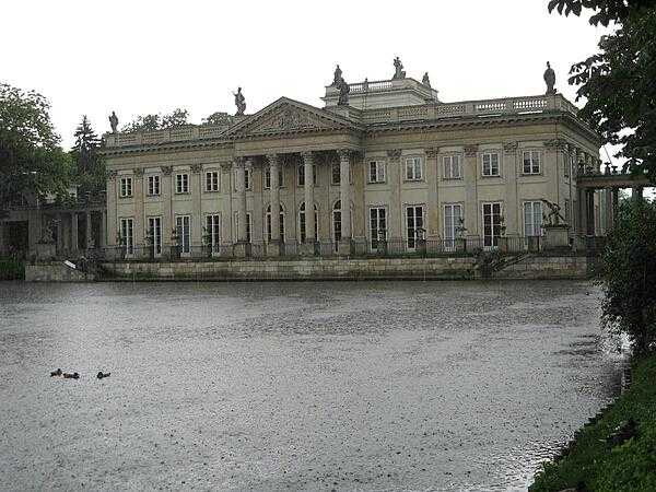 The Palac na Wodzie (Palace on the Water) located in the Park Lazienkowsi (Royal Baths Park) in Warsaw as seen during a downpour. The palace stands on an artificial island in Lazienki Lake, which it divides in two. The building is connected to the rest of the park by two arcaded bridges.
