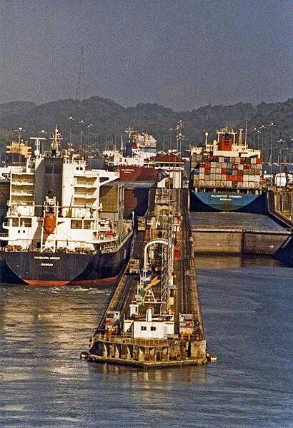 Container ships passing through locks in the Panama Canal.