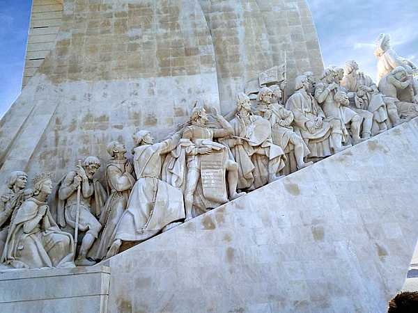 Closeup of the figures on the west side of the Padrao dos descobrimentos (Monument to the Discoveries) in Lisbon, which honors monarchs, explorers, navigators, cartographers, scientists, and missionaries from the Age of Discovery (15th and 16th centuries). The main statue of Prince Henry the Navigator (1394-1460), holding a model of a carrack (a three- or four-masted sailing ship), leads a procession of 32 figures (16 on either side ramp) on the monument.
