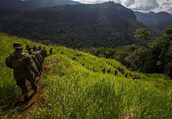 US Marines and soldiers from the Papua New Guinea Defence Force, hike the historical Kokoda trail during a military exercize in 2016. In 1942, Imperial Japanese forces invaded New Guinea, then a territory of Australia, in a bid to capture Port Moresby. In a bitterly contested campaign fought along the Kokoda Track from July to November 1942, the Australian Army turned back the invasion and eventually forced the Japanese back to their starting point. Ammunition and supplies were trucked 45 km (28 mi) from Port Moresby to Owers Corner where they were repacked in Uberi, a major supply base just beyond the Goldie River. From Uberi supplies had to be hand-carried along the tortuous track ahead. Native Papuans provided invaluable assistance in carrying supplies forward and evacuating casualties to rear area hospitals. Photo courtesy of the US Marine Corps/ Lance Cpl. Jesus McCloud.