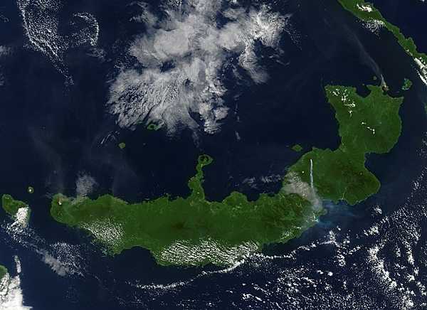NASA's Terra satellite captured this image of "the troublesome trio" on Papua New Guinea's New Britain island when they erupted simultaneously on 9 August 2005. Langila, Ulawun, and Rabaul Volcanoes all spewed ash at the same time, though not all with the same results. The westernmost volcano, Langila, and the easternmost volcano, Rabaul, sent fairly faint plumes of ash into the air, both of which drifted toward the northwest. Ulawun, the most active volcano in this picture, spit out a dense stream of ash that flew straight south. The volcanoes' proximity to each other and propensity for acting up at the same time suggest that they could be affected by the same tectonic activity underground. Photo courtesy of NASA.