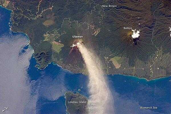 Numerous volcanoes contribute to the landmass of the island of New Britain, the largest in the Bismarck Archipelago of Papua New Guinea. One of the most active of these volcanoes - Ulawun - is also the tallest, with a summit elevation of 2,334 m (7,657 ft).

This astronaut photograph shows a plume of white steam and ash extending from the summit crater of the stratovolcano towards the northwest. The plume begins to broaden as it passes the southwestern coast of Lolobau Island, approximately 23 km downwind. Note that north is towards the lower left.

Ulawun is also known as &quot;the Father,&quot; with the Bamus volcano to the southwest also known as &quot;the South Son.&quot; The summit of Bamus is obscured by white cumulus clouds (not of volcanic origin) in this image. While Ulawun has been active since at least 1700, the most recent activity at Bamus occurred in the late 19th century. A large region of ocean surface highlighted by sunglint - sunlight reflecting off the water surface - is visible to the north-northeast of Ulawun. Photo courtesy of NASA.