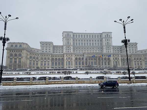 Exterior of the Palace of the People in Bucharest. The building was constructed between 1984 and 1997 on orders of Nicolae Ceausescu, the dictator of communist Romania. The structure is the world's third-largest building by floor area (after the Pentagon in Washington, DC and the Long'ao Building in China) with 1,100 rooms; it consists of 12 floors above ground and 8 floors below. The edifice hosts the two houses of Romania's Parliament (the Senate and the Chamber of Deputies), three museums, and an international conference center. Nonetheless, about two-thirds of the building remains unoccupied.